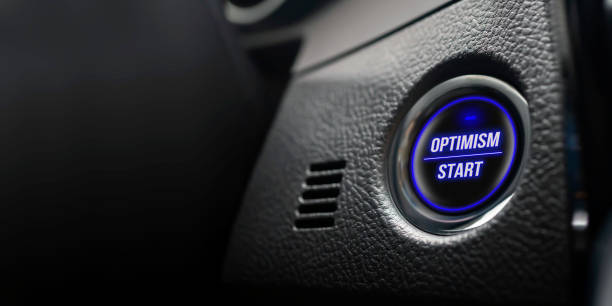 istock Business motivation concept. Ignition button with optimism start text in real car dashboard. 1158215714