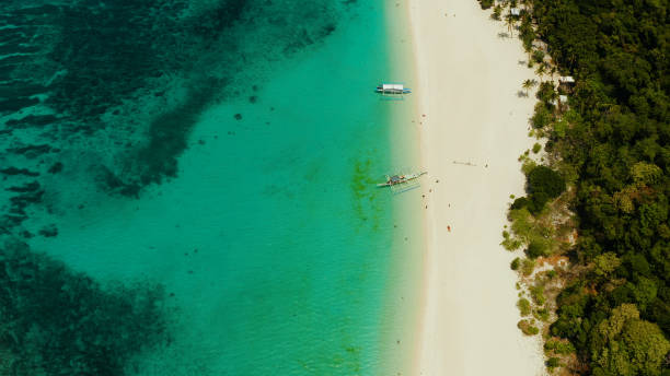 istock Tropical beach and turquoise lagoon water 1158215945