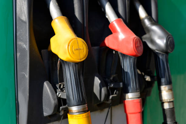istock Old multicolored pump nozzles at petrol station 1158216646