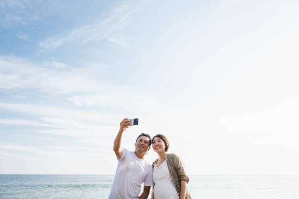 istock Mature couple taking selfie in the beach 1158219476