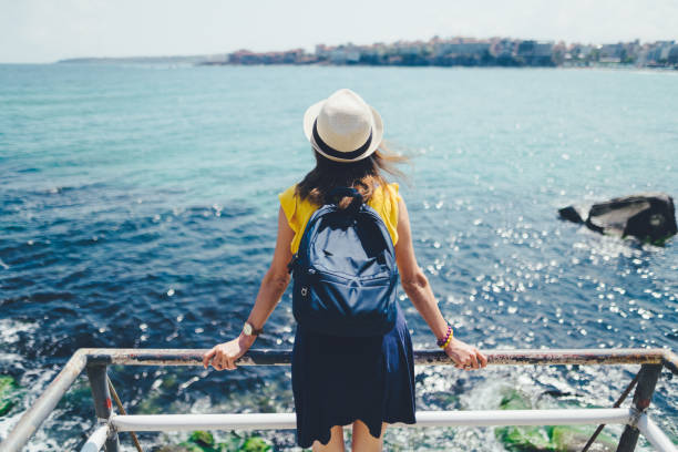 Rear view of young woman enjoying the seascape