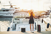 Woman at the marina ready for sailing with yacht