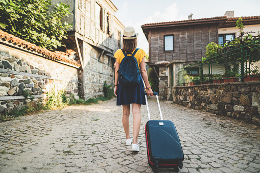 Rear view of woman with suitcase visiting the Balkans,Bulgaria