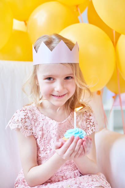 istock Lovely girl with birthday cupcake 1158220697