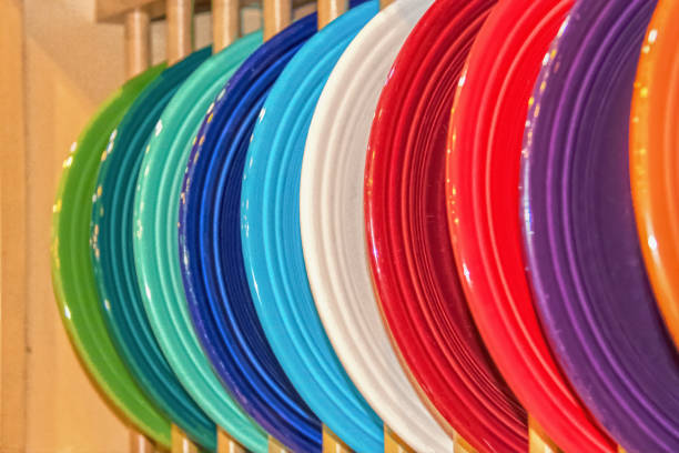 istock Multicolored stoneware plates displayed in wooden cabinet display case - selective focus 1158224387