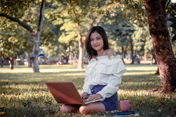 istock One women in Public park drink coffee and read a book 1158225437