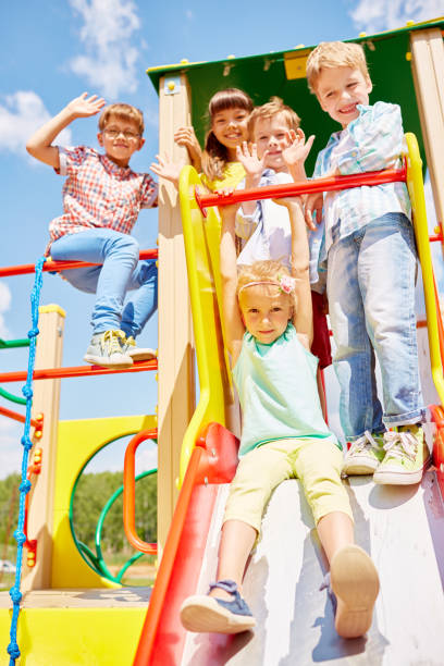 istock Group of cheerful kids on playground 1158226494
