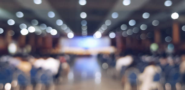 blurred people sitting at the conference stock photo