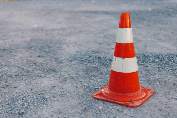 istock traffic cone, with white and orange stripes on the road, copy space 1158226955