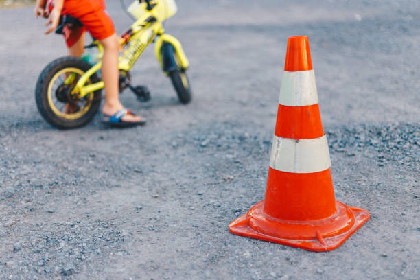 istock traffic cone, with white and orange stripes on the road, copy space 1158226956