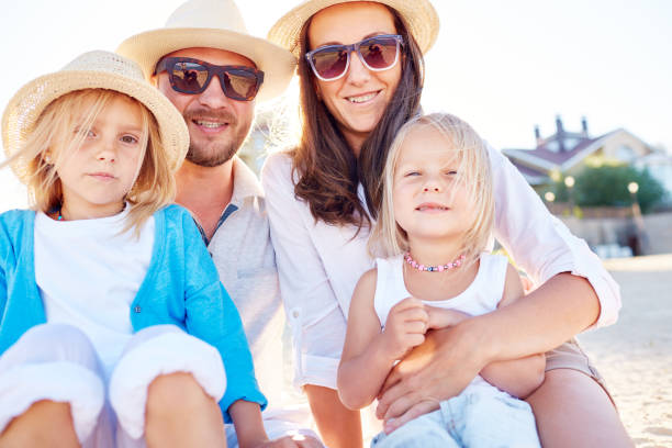 istock Adult parents with kids on seashore 1158227577