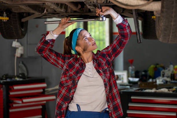 istock Two young car mechanics  colleagues servicing the car 1158228545