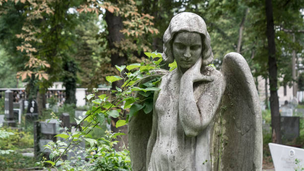 istock Guardian Angel Sculpture In A Graveyard 1158228905