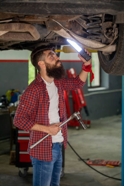 istock Two young car mechanics  colleagues servicing the car 1158229964