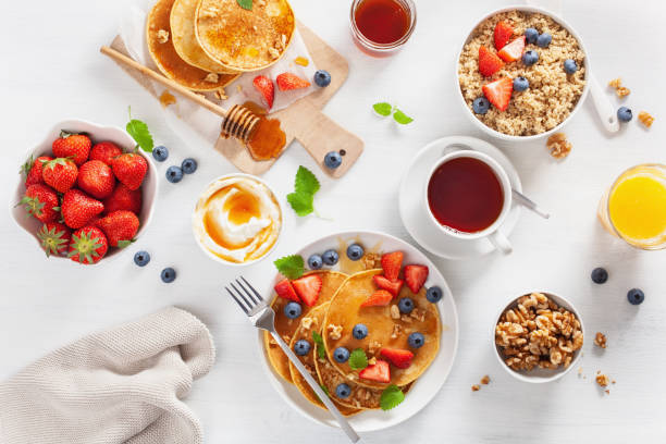 pancakes with blueberry strawberry honey and quinoa for breakfast - norway maple imagens e fotografias de stock