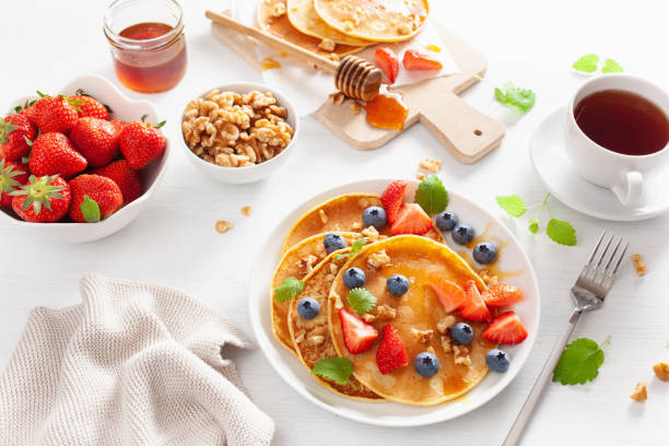 istock pancakes with blueberry strawberry honey and nuts for breakfast 1158231510