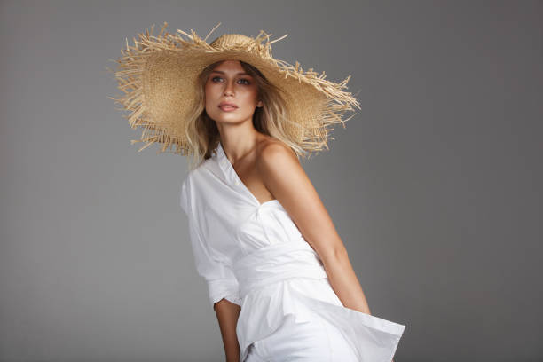 istock Beautiful woman wearing straw hat 1158231560