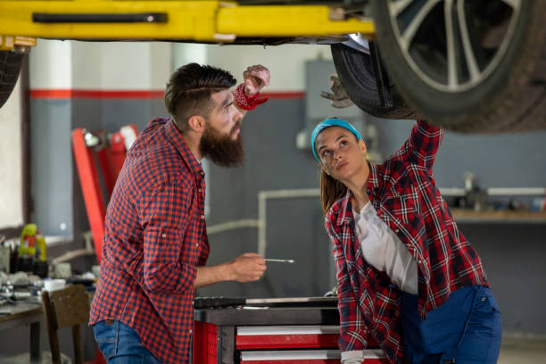 istock Two young car mechanics  colleagues servicing the car 1158231711