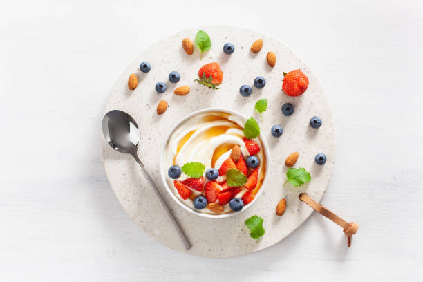 yogurt with strawberry blueberry honey almond for breakfast - norway maple imagens e fotografias de stock