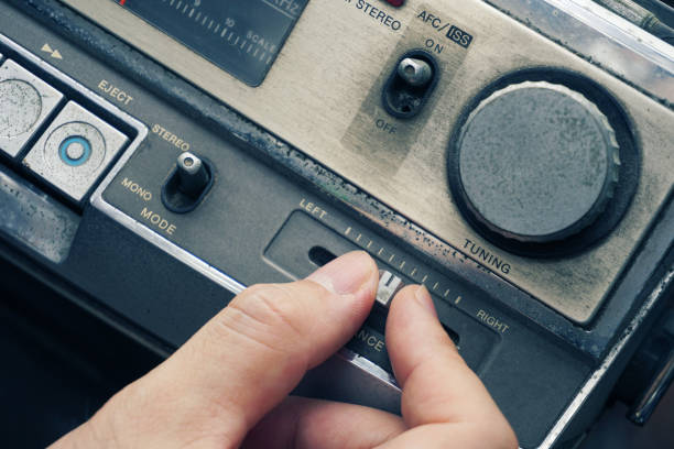 istock Hand adjust volume tuning vintage cassette tape . 1158231813