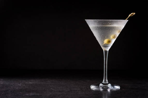Classic Dry Martini with olives Classic Dry Martini with olives on black background martini stock pictures, royalty-free photos & images