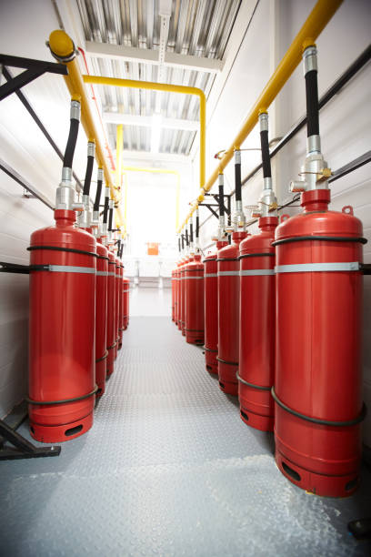 Air tanks in industrial room Background image of narrow corridor of industrial room with air tanks connected to metal tube, fire-extinguishing appliance repression stock pictures, royalty-free photos & images