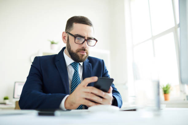 istock Business manager checking phone in office 1158235724