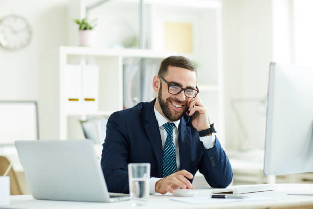 istock Excited manager talking on phone 1158235740