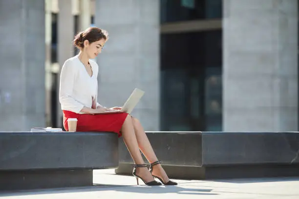 Photo of Elegant Businesswoman Using Laptop Outdoors