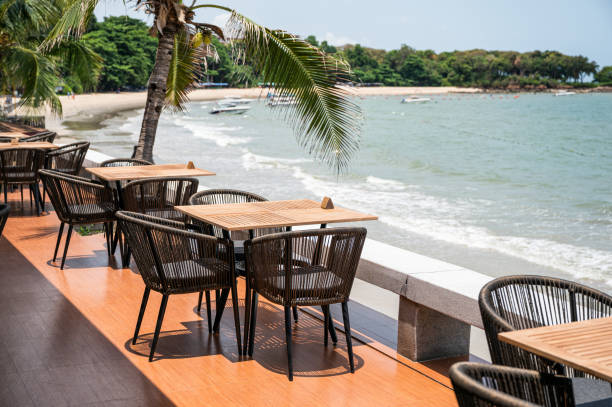 istock Wooden dining table on restaurant patio at seaside 1158237311
