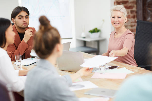 istock Handing Papers at Meeting 1158237431
