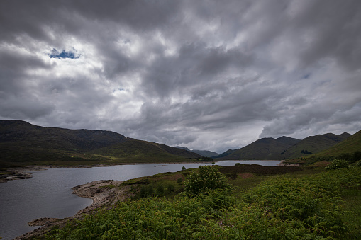 Loch Cluaine looking back towards Glen Sheil and the Kintail Mountains on a gloomy summers day. Scotland.