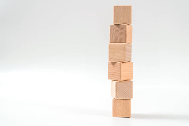 istock brown wood bricks tower, wood cube arrange in pyramid shape ,business concept 1158238011