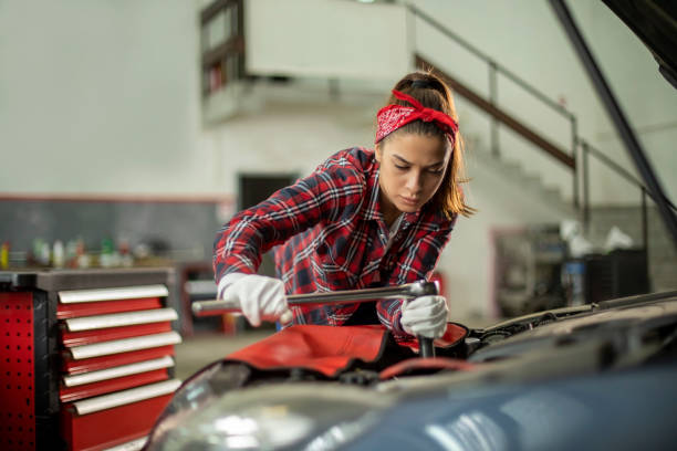 istock Two young car mechanics  colleagues servicing the car 1158238606