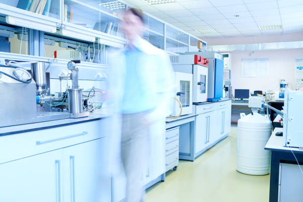 istock Scientist in defocus walking in lab 1158238946