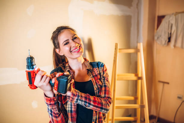 istock Young woman with drill 1158240151