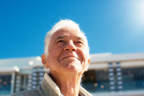 istock Handsome senior man looks up at the sky 1158240413