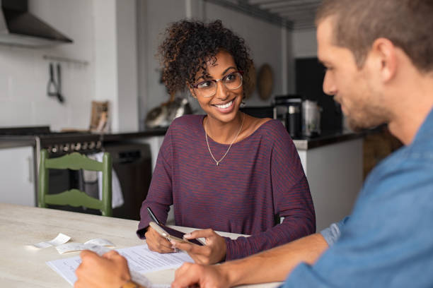 istock Young smiling couple managing expenses 1158242719