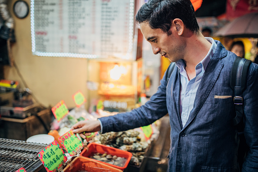 Businessman buying street food in Taiwan