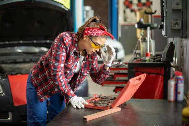 istock Two young car mechanics  colleagues servicing the car 1158244333