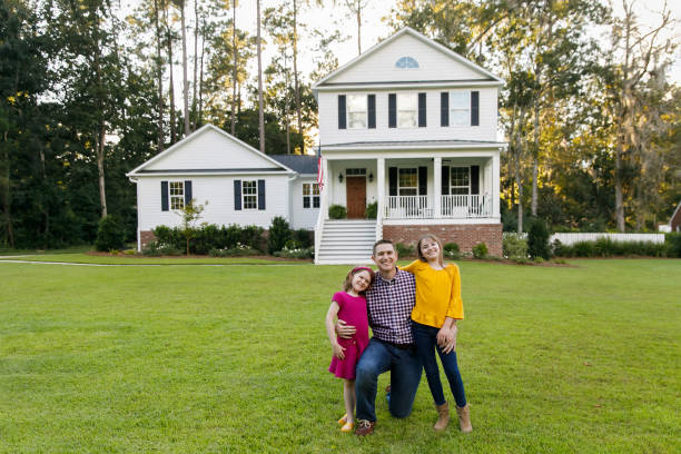 istock dad and two daughters outside their home 1158244659