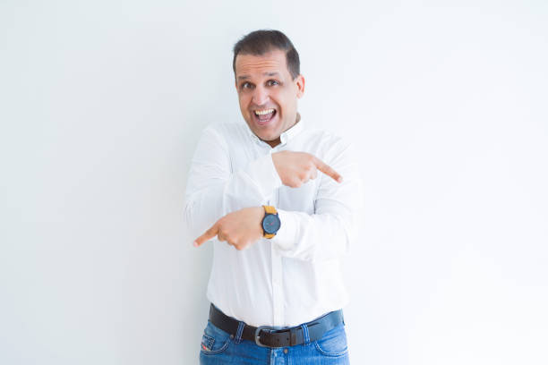istock Middle age business man smiling and pointing to the side over white background 1158245040