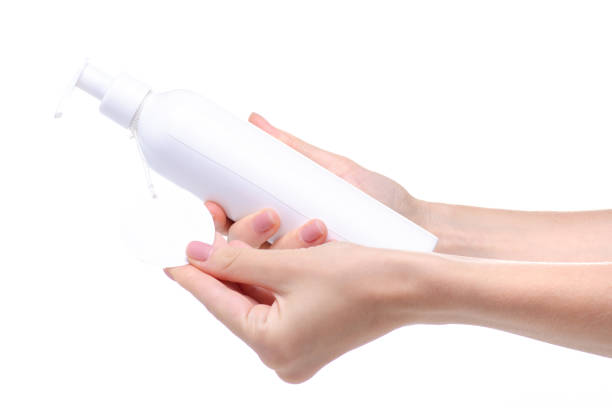 istock White bottle with dispenser beauty product in hand 1158245349