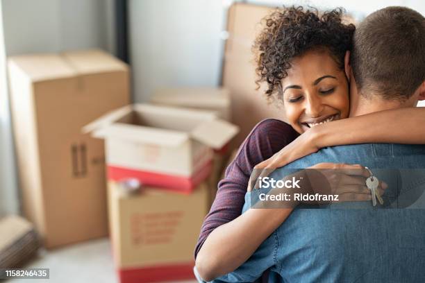 Woman Hugging Man And Holding Home Keys Stock Photo - Download Image Now - Moving House, Couple - Relationship, House