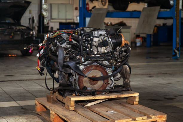 Close up view of hands working on a car engine in repair shop