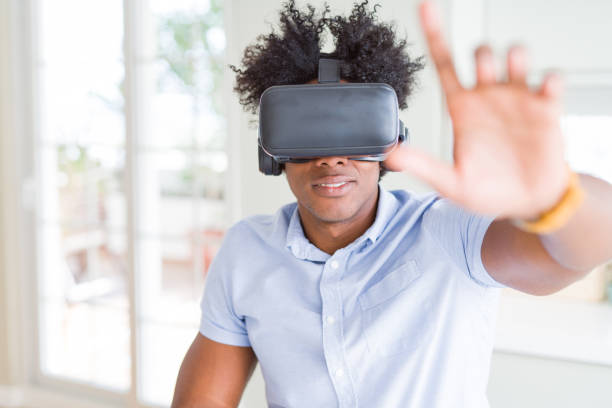 istock African American man having fun playing with virtual reality glasses 1158246751