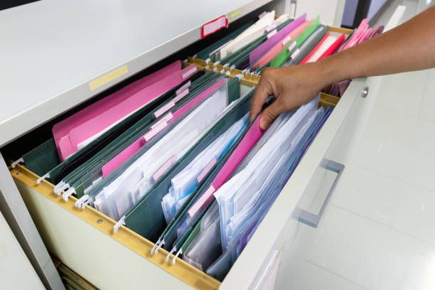istock Hand of Man Search files document in a file cabinet in work office 1158246939
