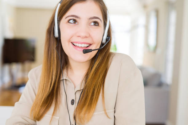 istock Beautiful young operator woman wearing headset at the office smiling looking side and staring away thinking. 1158247206