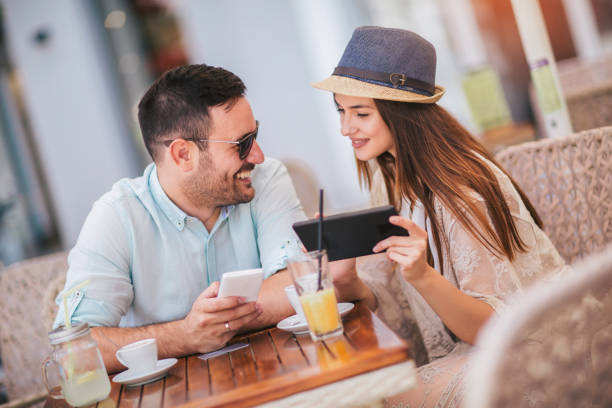 istock Happy young couple shopping online while sitting in a cafe. 1158248542