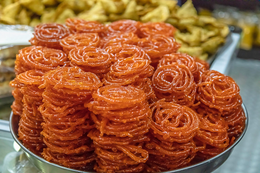 Jalebi desert original sweet delecacy from India seen here on display in Fordsburg, Johannesburg.\nFordsburg is an old historical area where mainly indian, turkish, pakistani and other east asian cultures coexist with restaurants and spice dealers.